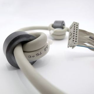 Spliced flat round cable with ferrite cores, IDC-connector and ring terminal